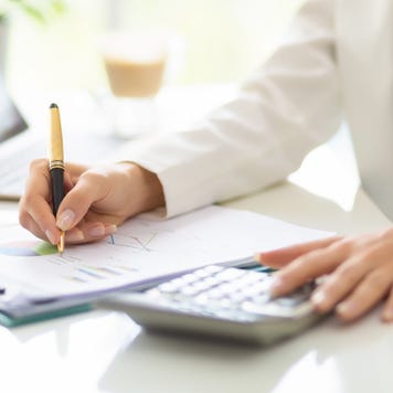 Woman working with business document and laptop on the table