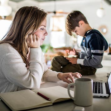 Mom researching on laptop in kitchen