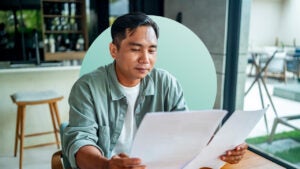 man reading paperwork side by side
