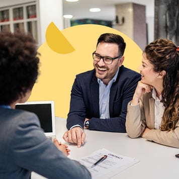 Financial manager meeting with couple in bank branch office