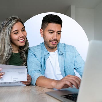 Young couple paying bills online