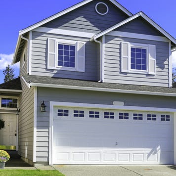 The exterior of a two-story single-family home with attached garage and driveway