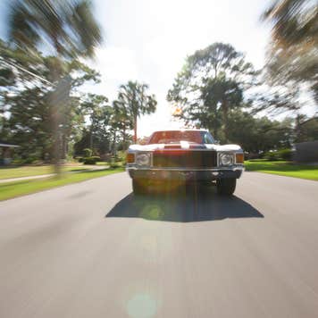 1970's car driving on a street