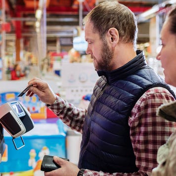 man paying with credit card at the supermarket checkout
