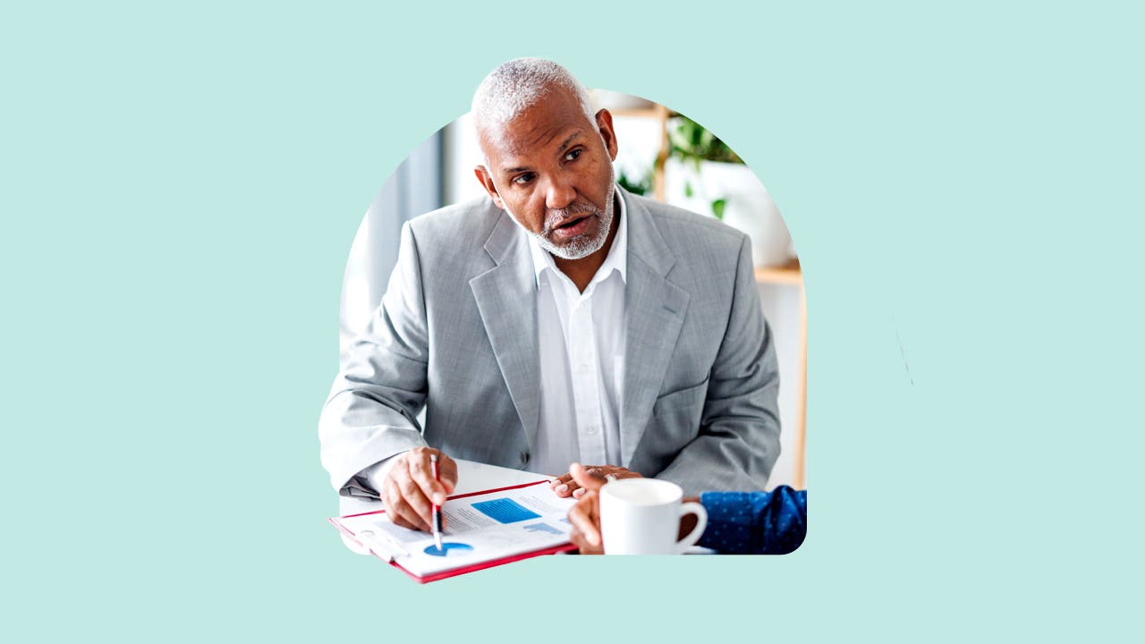 A financial planner references a graph.