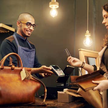 Woman paying with credit card at store