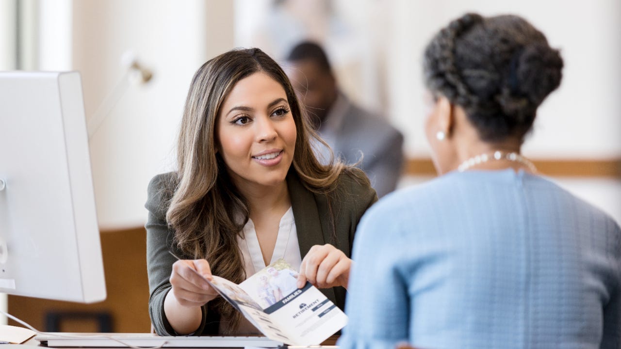 Bank teller with customer