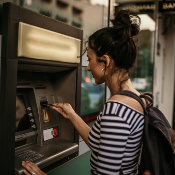 Woman getting cash from ATM