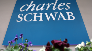 A sign is posted outside of a Charles Schwab office in San Francisco, California.