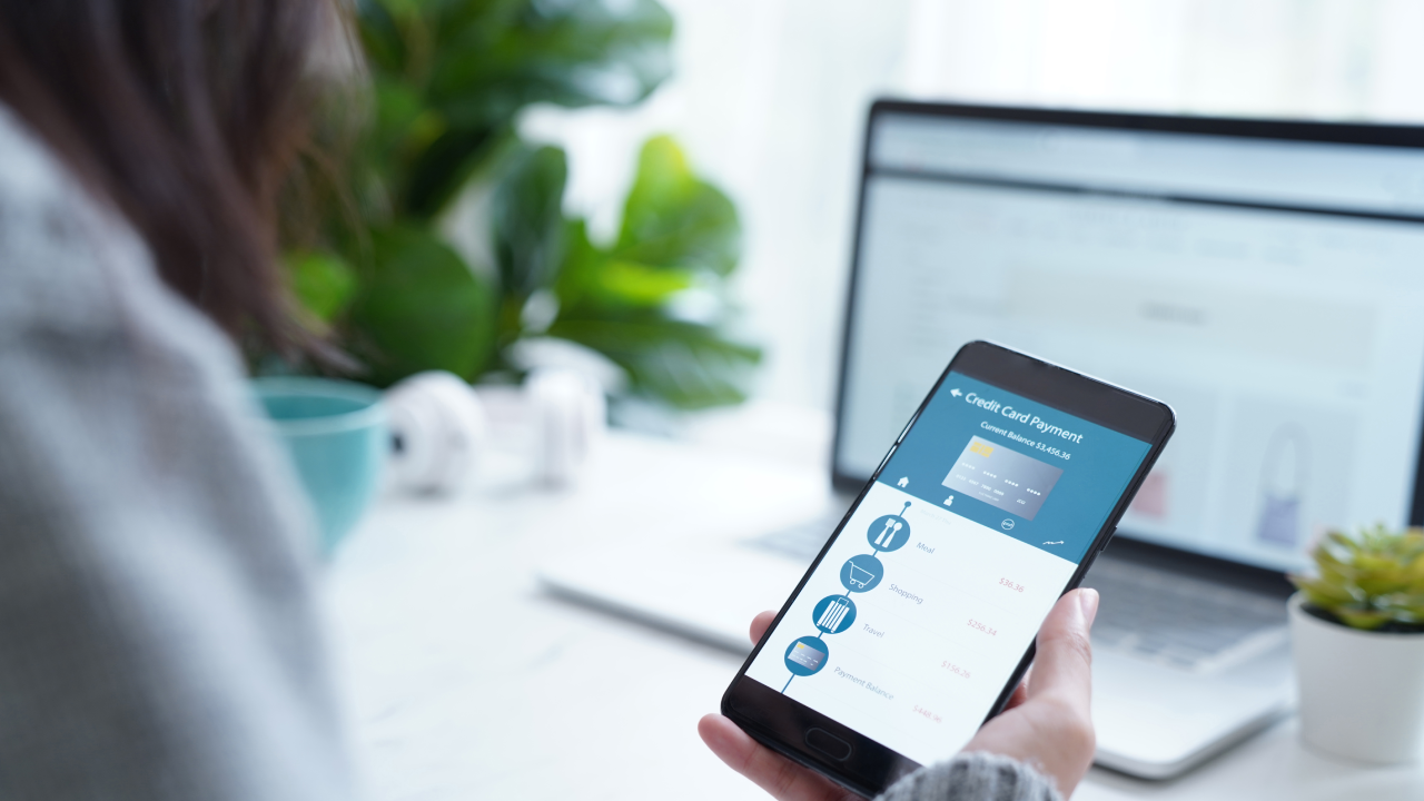 Woman checking credit card outstanding balance on mobile banking account